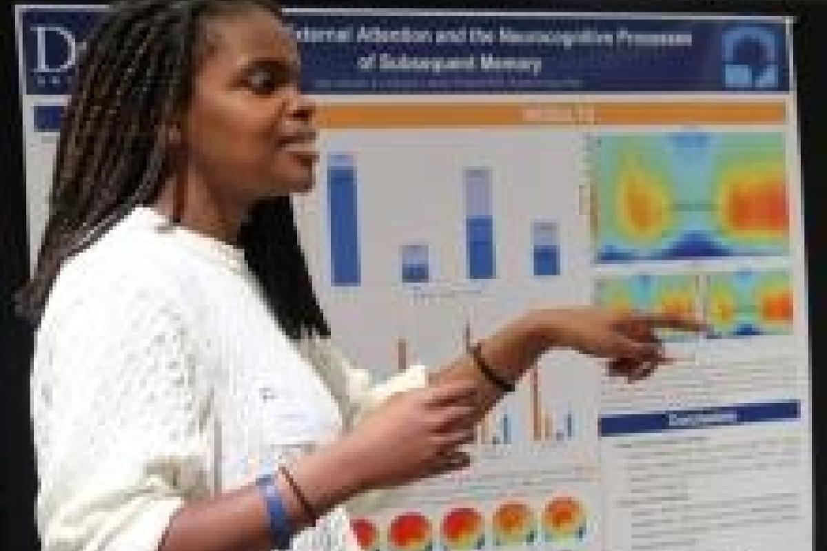 Sade Abiodun, Neuroscience major graduating with distinction, discusses the poster representing her thesis project