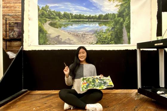 Athena Yao with a recent oil painting.